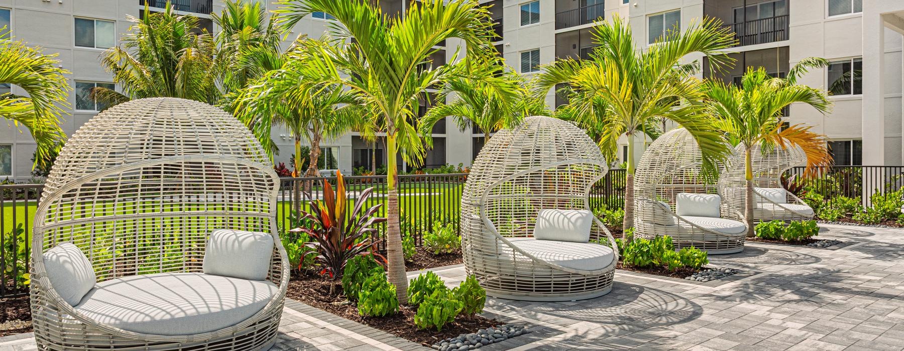 a courtyard with a fountain and chairs
