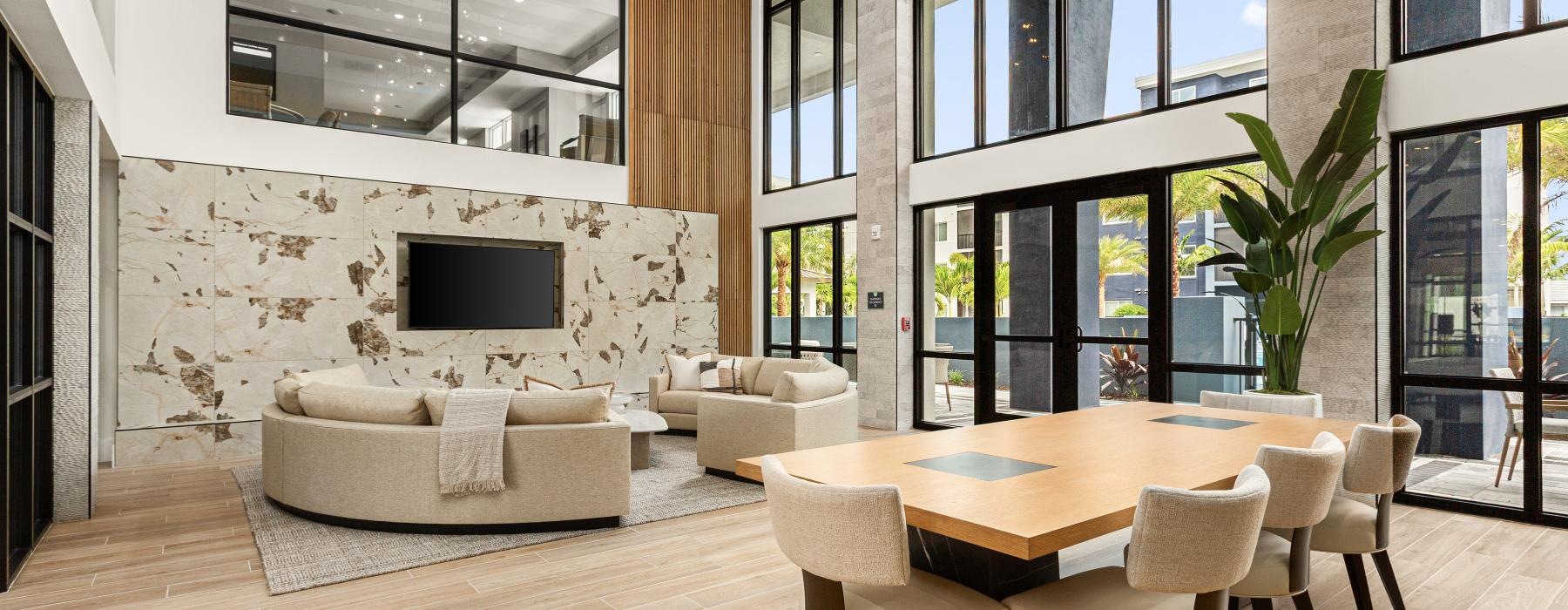 a room with a table chairs and a tv